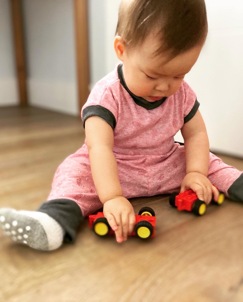 infant playing with toys