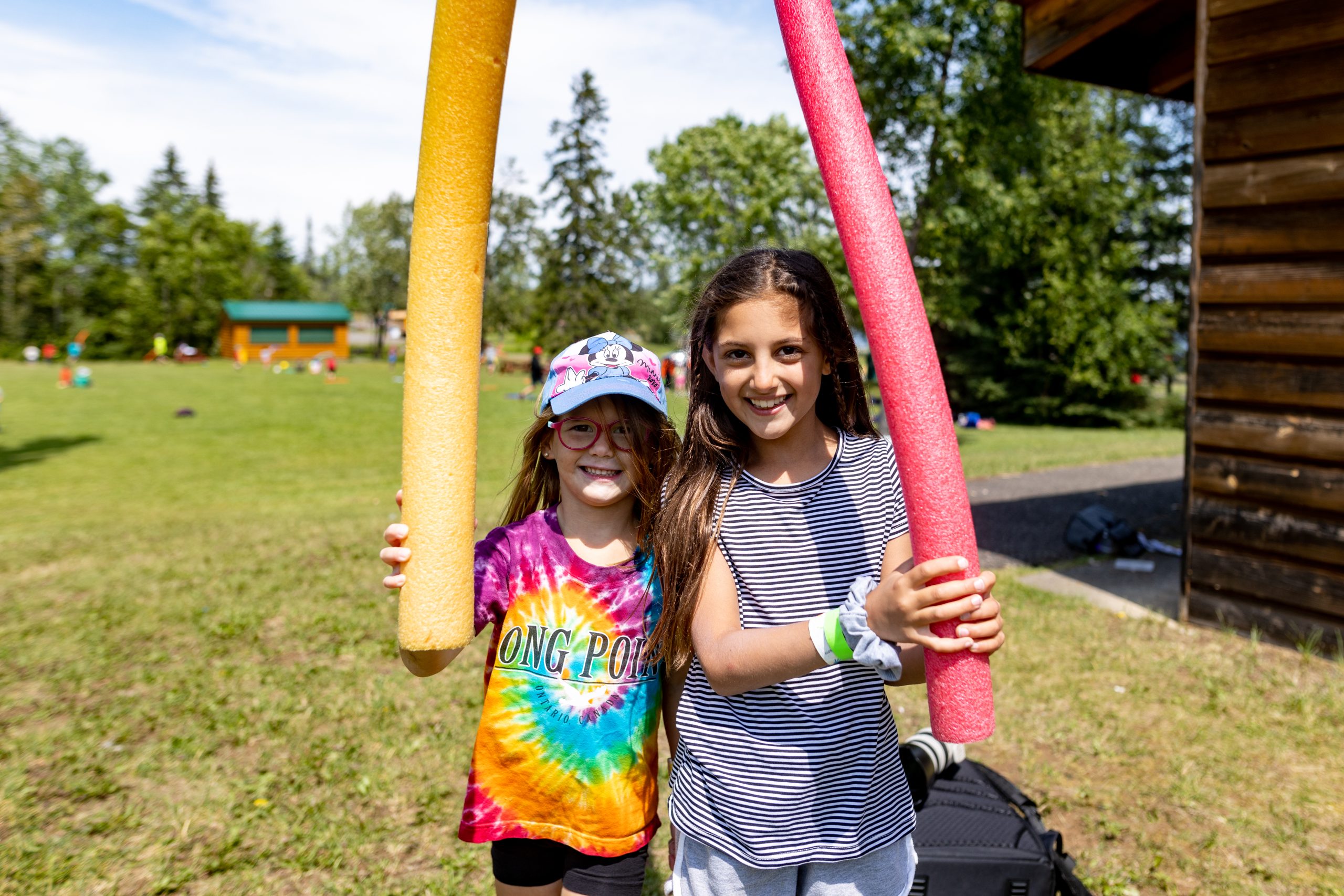Chippewa participants playing outside with pool noodles.